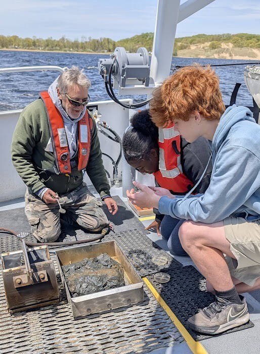 Students viewing water samples aboard the W.G. Jackson research vessel